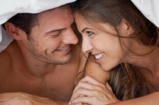 زن و شوهری خوشحال در زیر پتو که تمایل جنسی بالایی دارند